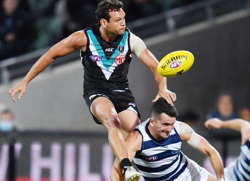 AFL player going for a catch in a Port Adelaide and Geelong game